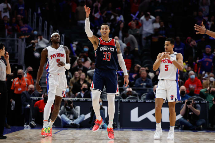 Washington Wizards forward Kyle Kuzma (33) celebrates his three point basket in overtime as Detroit Pistons forward Jerami Grant (9) reacts at Little Caesars Arena.